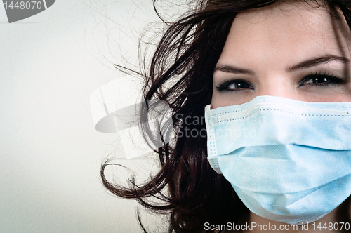 Image of A girl in a protective mask against white isolated background