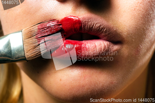 Image of Conceptual makeup with a little bit of red paint