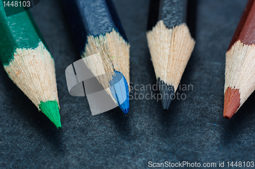 Image of Colorful pencils on dark background lined up