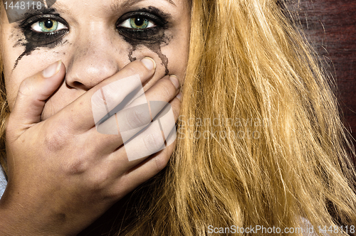 Image of Blond girl covering her mouth