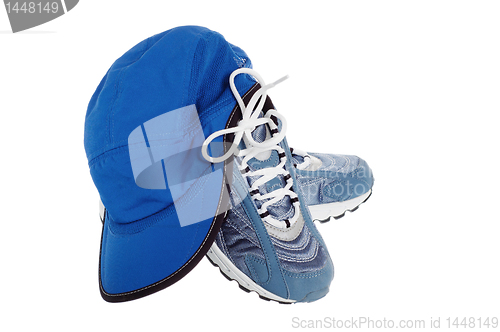 Image of sports shoes and Cap isolated on white 