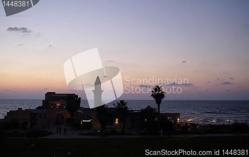 Image of old minaret in a sunset sea