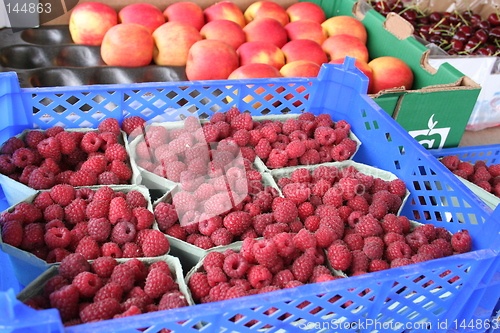 Image of Raspberries,peaches and cherries in market stall