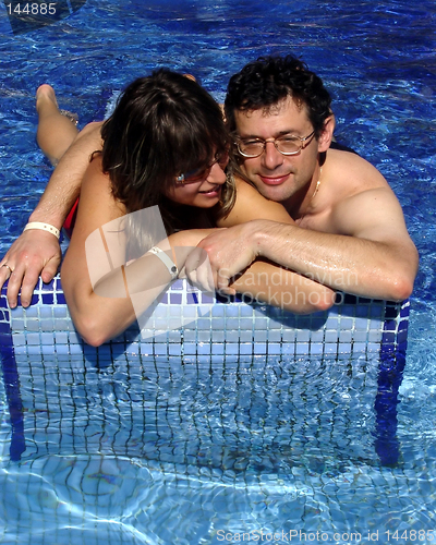 Image of Good looking couple in the pool