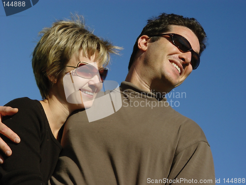 Image of Happy couple against blue sky