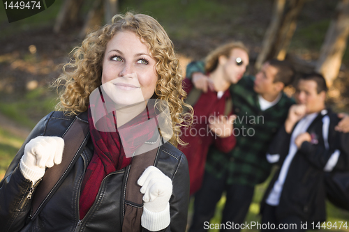 Image of Pretty Young Teen Girl with Boys Behind Admiring Her