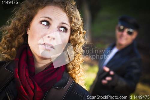 Image of Pretty Young Teen Girl with Man Lurking Behind Her