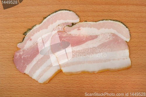 Image of sliced bacon on a wooden cutting board