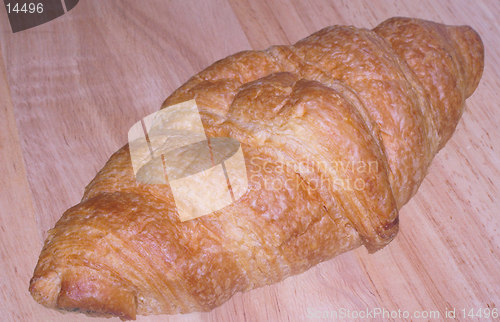 Image of croissant on a wooden board