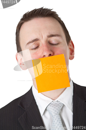 Image of Businessman with a blank  adhesive note over his mouth