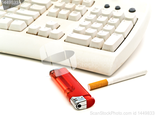 Image of keyboard, cigarette and  lighter