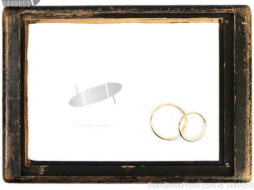 Image of vintage wooden frame and wedding rings