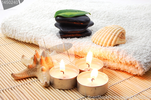 Image of foldet white bath towel and zen stones