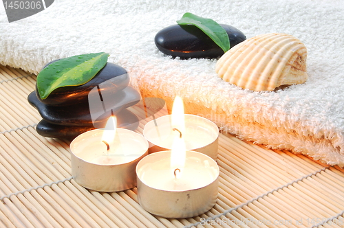 Image of foldet white bath towel and zen stones