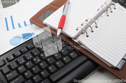 Image of computer keyboard and organizer