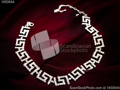 Image of necklace at red fabric