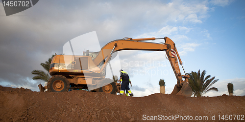 Image of excavator works on construction of new road