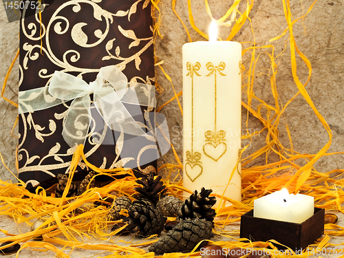 Image of  festive composition with gift, candle and cones 