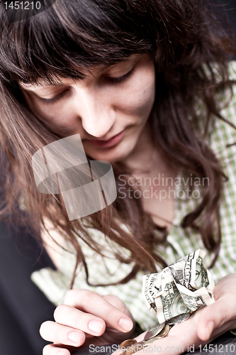 Image of begging young woman with money 