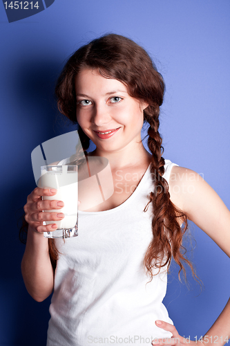 Image of young woman enjoying a glass of milk 