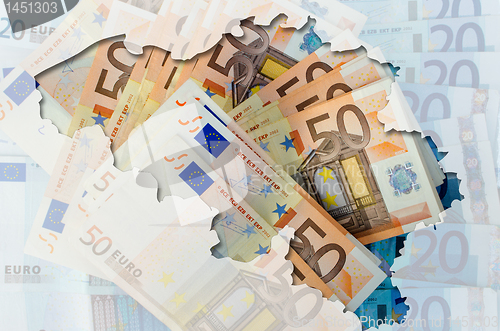 Image of Outline map of Belgium with transparent euro banknotes in backgr