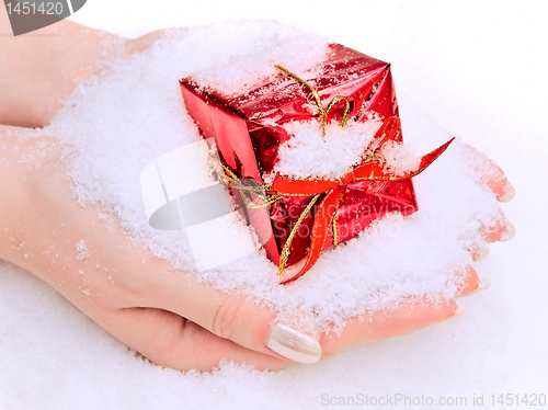 Image of hands with gift in snow