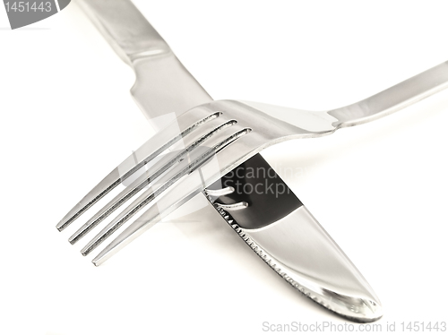 Image of Crossing knife and fork against white