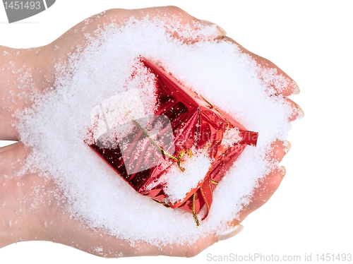 Image of hands with red gift in snow