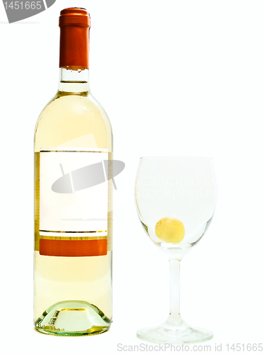 Image of white wine near wineglass with grape