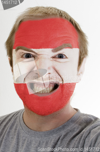 Image of Face of crazy angry man painted in colors of austria flag