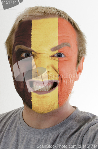 Image of Face of crazy angry man painted in colors of belgium flag