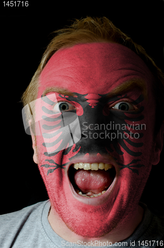 Image of Face of crazy angry man painted in colors of albania flag