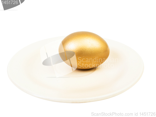Image of golden egg at plate