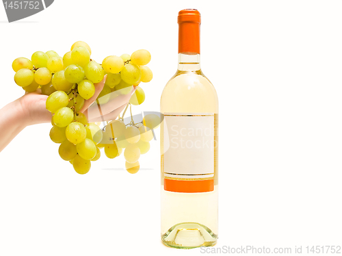 Image of white wine with grape in hand