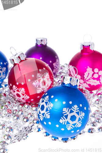 Image of christmas balls with snowflake symbols