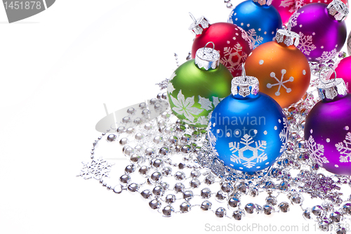 Image of christmas balls with snowflake symbols