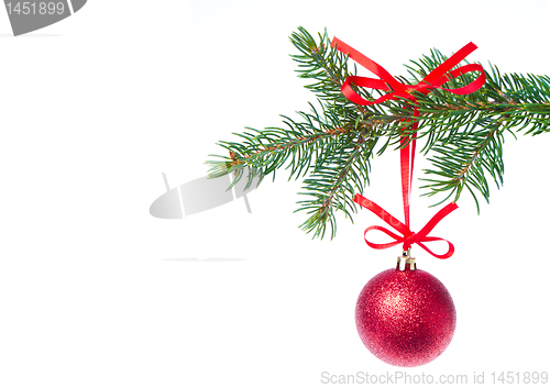 Image of red christmas ball hanging from tree