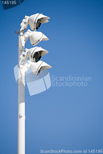 Image of spotlights against blue sky