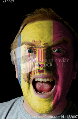 Image of Face of crazy angry man painted in colors of andora flag