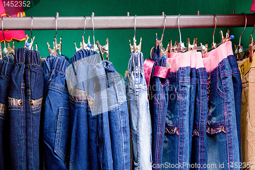 Image of Denim pants on a hanger for children in the store