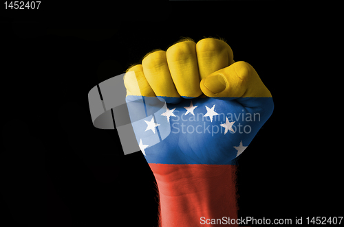 Image of Fist painted in colors of venezuela flag