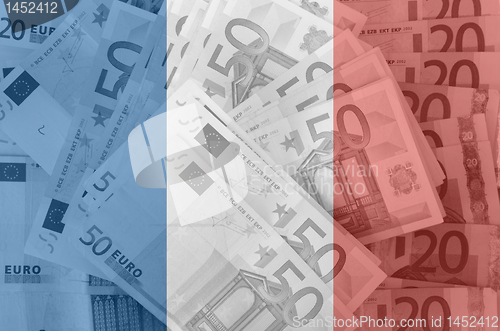 Image of flag of France with transparent euro banknotes in background 