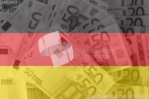 Image of flag of Germany with transparent euro banknotes in background 