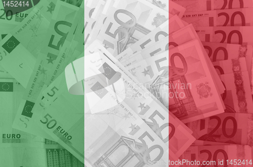 Image of flag of Italy with transparen t euro banknotes in background 