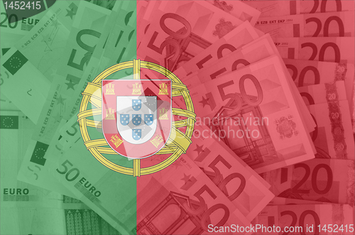 Image of flag of Portugal with transparent euro banknotes in background 
