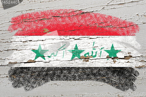 Image of flag of iraq on grunge wooden texture painted with chalk  