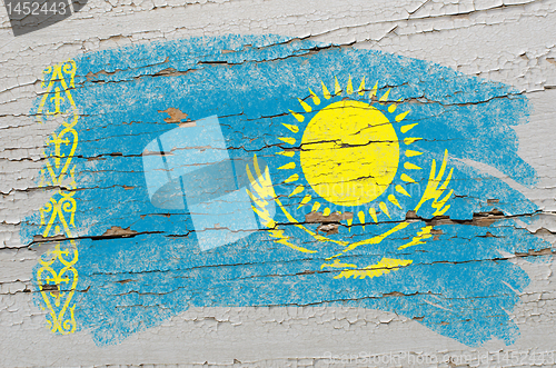 Image of flag of khazakstan on grunge wooden texture painted with chalk  