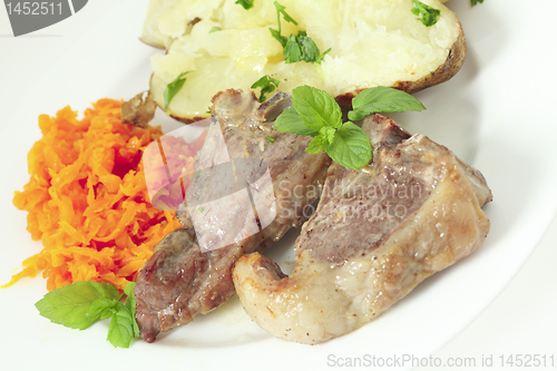 Image of Lamb chops carrots and baked potato