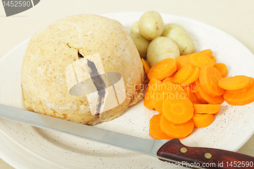 Image of Steak and kidney pudding ready to serve