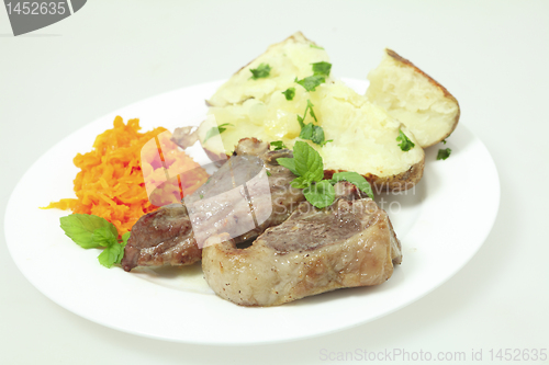 Image of Lamb chops carrots and baked potato plate